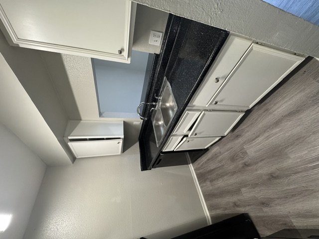 Updated model kitchen with black countertops at Terraces at 2602