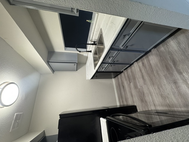 Updated model kitchen sink and counters at Terraces at 2602